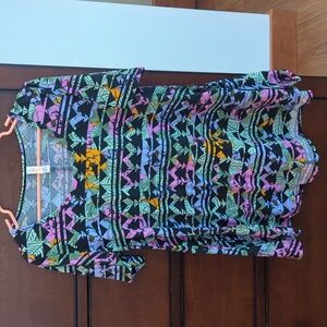 Lularoe tunic shirt size small. Black background with vibrantly colored pattern